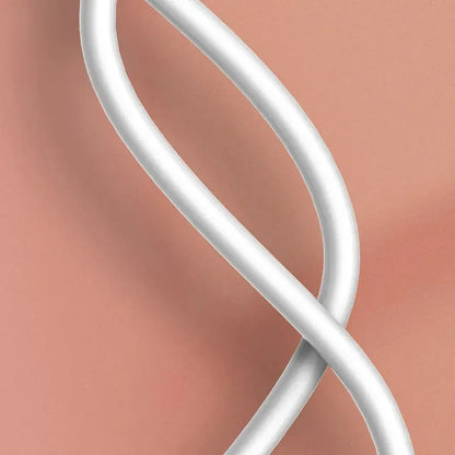 Close-up of a smooth white cable against a soft peach background